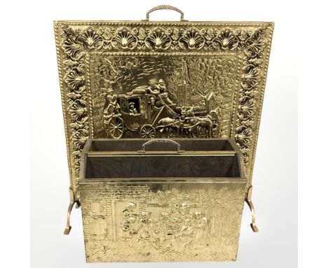 An embossed brass fire screen, width 52 cm and a magazine rack 