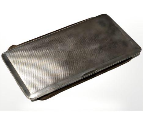 A large silver cigarette case with engine turned decoration, Birmingham marks, 17 cm x 9 cm.