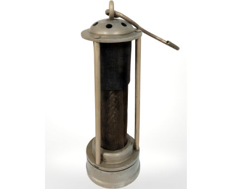 A miner's lamp with central gauze lining.