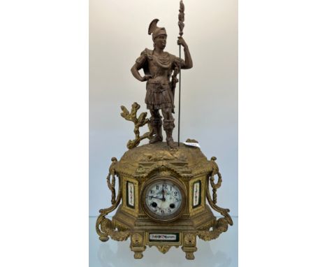 19th century French mantel clock; Metal centurion figure to the top, gilt painted body and enamel panels, Enamel dial and com