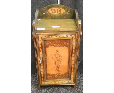 Arts and crafts smokers cabinet; Stained green, Shamrock trims and designed with an Irish man smoking a pipe to the door pane