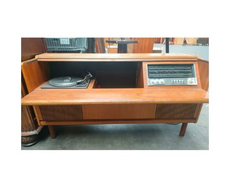 A mid century turn table in fitted teak cabinet fitted with a Ferguson radio