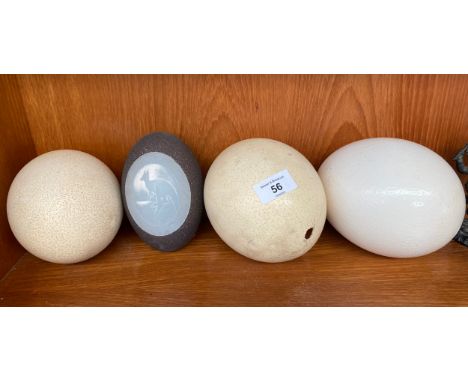Four various ostrich eggs; Australian Aboriginal art ostrich egg detailing a carved wallaby 