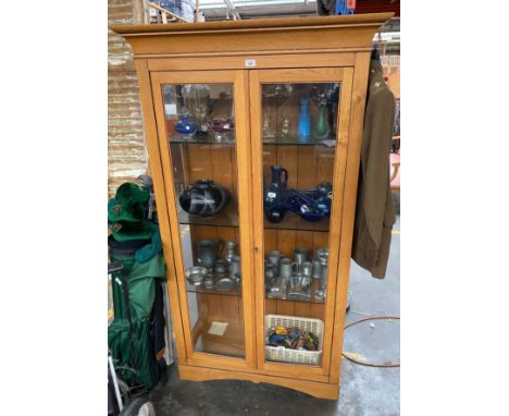 Contemporary light oak and glass front and side display cabinet- fitted glass shelves. Comes with key. 