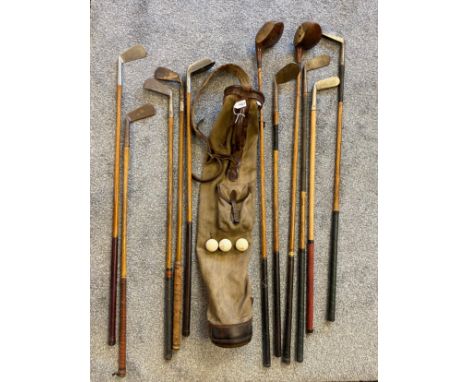Antique golf bag and hickory shaft golf clubs; R. Simpson Carnoustie, Niblick, T. Mounce, Two wooden head drivers, Forcan &am