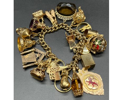 A Heavy antique 9ct yellow gold charm bracelet fitted with a collection of 9ct yellow gold charms, also includes an 18ct yell