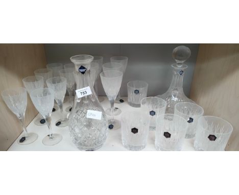 Shelf of Stuart Crystal decanters, wine glasses and whisky glasses 