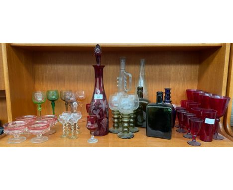 Shelf of antique and vintage art glass; Facet cut ruby glass decanter with stopper, Four green ribbed and etched vine design 