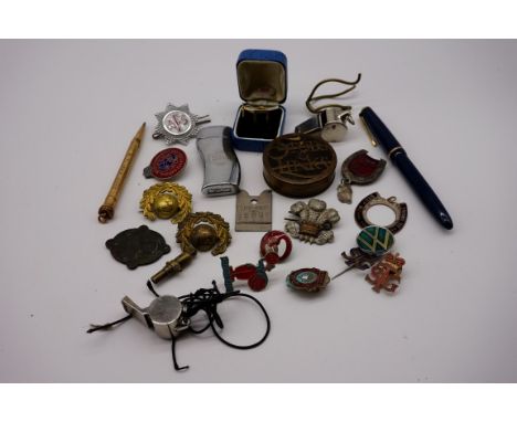 A collection of various badges and miscellany etc, to include a Stella Artois lighter and a Parker fountain pen. 