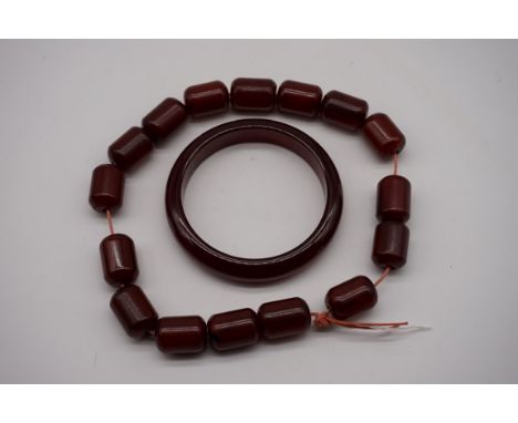 A string of cherry amber beads, 36cm long; together with a similar bangle, 106.4g 