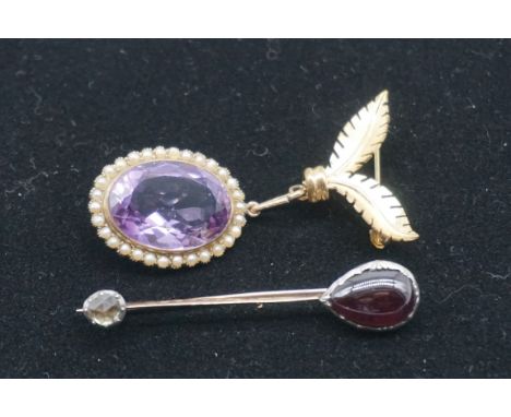 A large oval amethyst and seed pearl pendant, stamped 9ct, having a metal brooch fitting attached, 28 x 22mm (without fitting