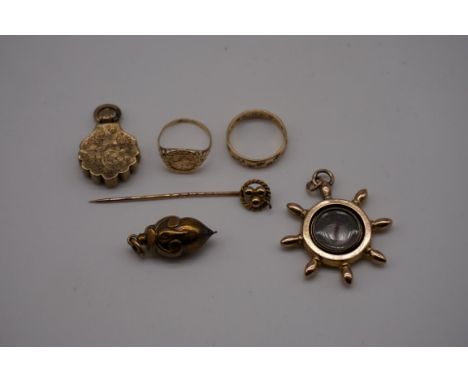 A small group of yellow metal items, comprising: two open lockets; two rings; a stick pin; and a bauble. (6) 