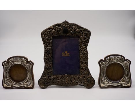 A Victorian silver photograph frame, by Mappin &amp; Webb, London 1897, 13.5 x 20cm; together with a similar pair of Edwardia