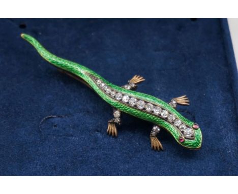 A diamond and green enamel salamander yellow metal brooch, having cabochon ruby eyes, 7.5cm long, 11.4g gross weight. 