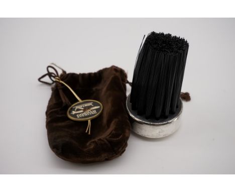 An American sterling silver mounted hat brush, by Gorham, 6cm diameter, in a velvet travel bag. 