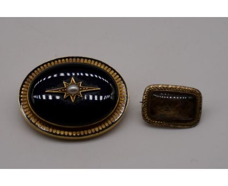 A Victorian oval black chalcedony pearl set mourning brooch/pendant, the yellow metal mount having enamel decoration and glas