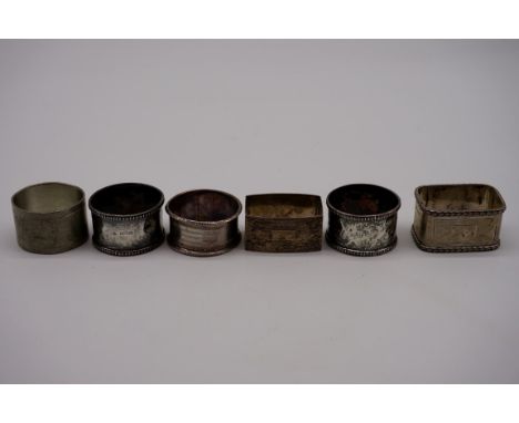 Five various silver napkin rings, 118g; together with a pewter example. (6) 