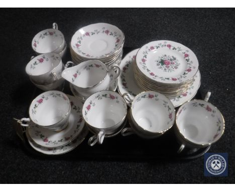A tray containing a thirty-eight piece floral bone china tea service