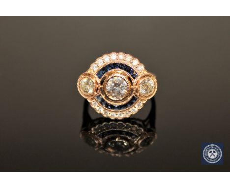 A 14ct yellow gold sapphire and diamond Art Deco style cluster ring, the central brilliant-cut diamond weighing 0.60 carat, c