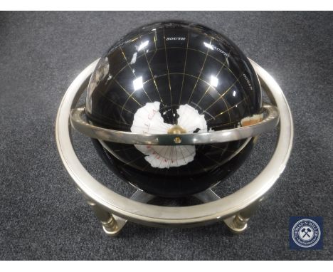 A gemstone globe on stand