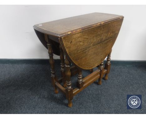 An antique oak gate leg table 