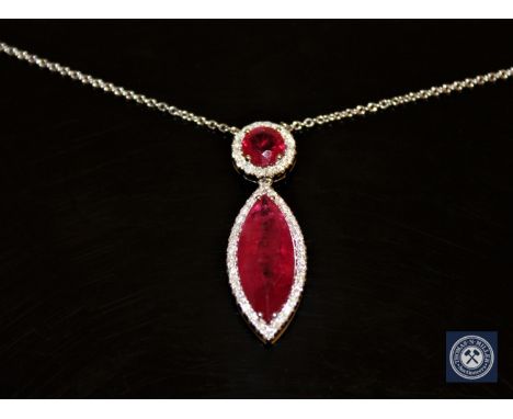 An 18ct white gold ruby and diamond necklace/pendant, a marquise-cut pinkish/red ruby weighing 5.82 carats beneath a round-cu