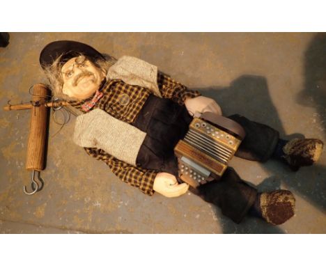 Old man playing accordian puppet with ceramic hands and head 