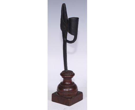 An 18th/19th century wrought iron nip rush light holder, turned oak base, 28cm high 