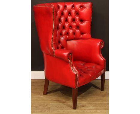 A George III design barrel-back armchair, stuffed-over deep-button upholstery with studded border, tapered square forelegs, 1