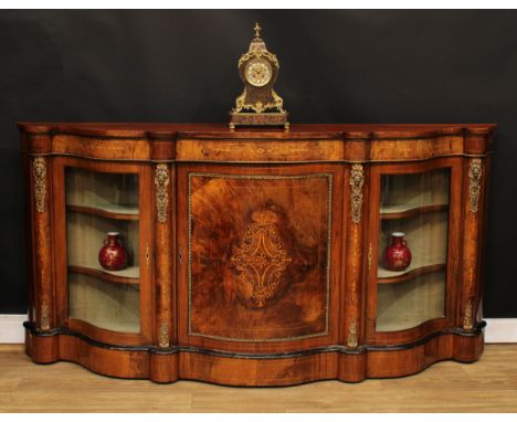 A Victorian gilt metal mounted walnut and marquetry serpentine credenza, slightly oversailing top above a panel door inlaid w