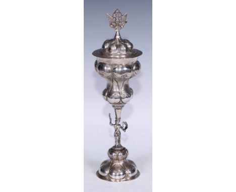 A Russian silver standing cup and cover, lobed and chased with scrolls, figural stem, crowned double-eagle finial, 32cm high,
