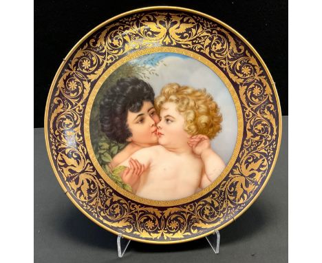 A large 19th century Vienna charger, the central panel decorated with two children, beneath leafy bush, signed S Stadler, wit