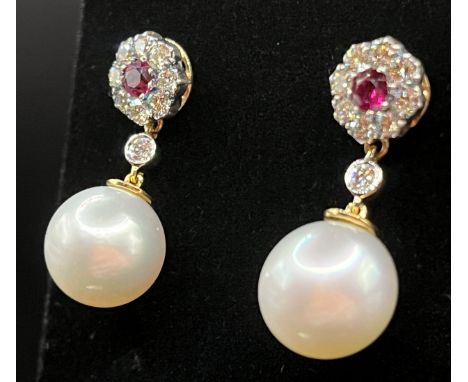 A pair of 18ct gold 11mm pearl drop earrings, suspended from ruby and diamond flowerheads