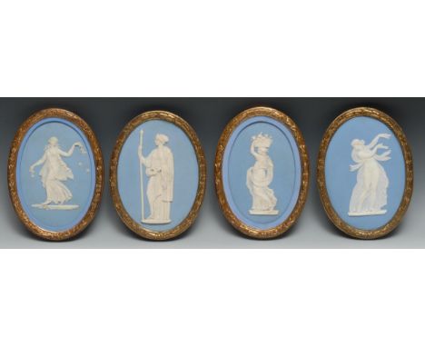 A pair of 19th century Wedgwood Jasperware oval plaques, typically sprigged with classical figures in white, on a light blue 