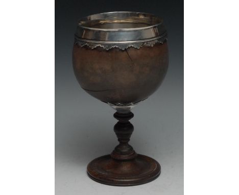 A George II silver mounted coconut cup, shaped and engraved pendant border, turned base, 19.5cm high, dated 1743 