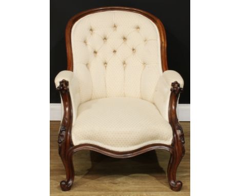 A Victorian rosewood library chair, stuffed-over upholstery, deep-button back, serpentine-front seat, cabriole forelegs, 79.5