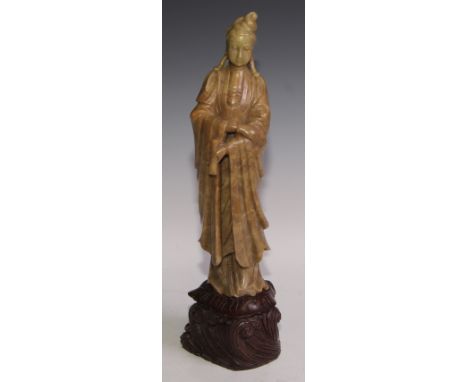 A Chinese celadon soapstone carving, of Guanyin, well carved with a serene face, wearing flowing robes and holding a scroll, 