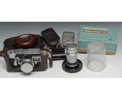 A Leica M3 camera, with wide angle and long lenses, serial no.1014323, brown leather case; an associated light meter, boxed 