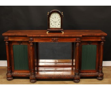 A William IV rosewood break-centre library side cabinet, slightly oversailing top above a pair of short drawers, the central 