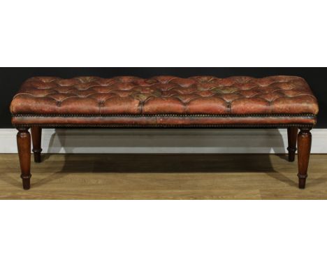 A Victorian style ‘Chesterfield’ window seat, stuffed-over deep-button top, turned legs, 39cm high, 126cm wide, 42cm deep 