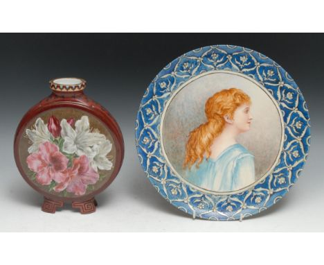 An Aesthetic Movement circular charger, painted with a portrait of a young girl with red hair, Iznik border, 30.5cm diam, sig