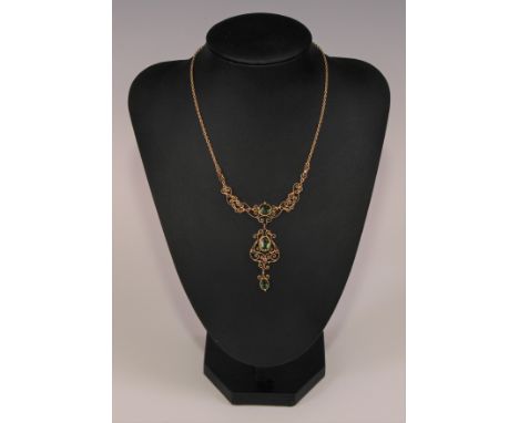 An Edwardian style green tourmaline and ruby open filigree necklace by Murrle Bennett, the stones finely set within a scroll 