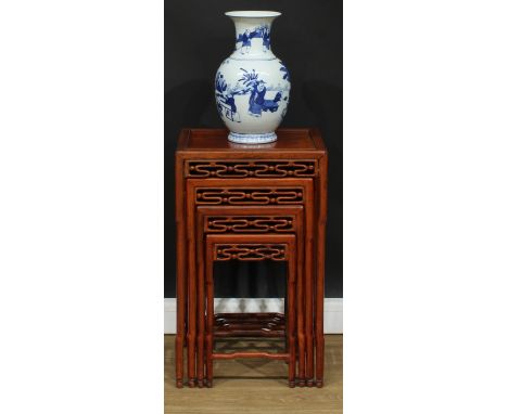 A set of Chinese hardwood quartetto tables, each with a rectangular panel top above a shaped and pierced frieze, humpback str