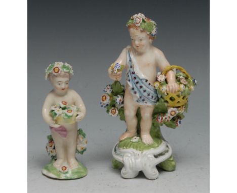 A Derby Patch Mark cherub, standing holding a basket of flower, wearing a floral chaplet, 9cm high, c.1770;  another, Derby t