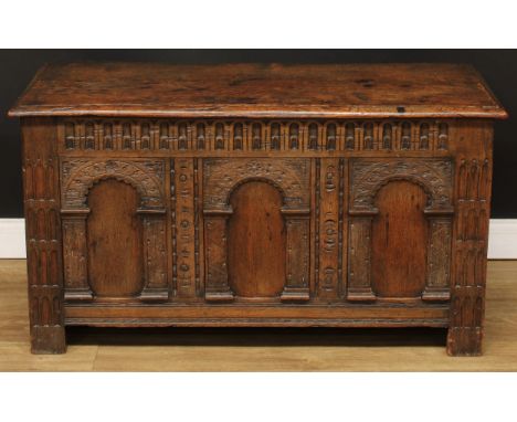 An oak blanket chest, hinged rectangular top above an architectural front with nulled frieze, stile feet, 63cm high, 117cm wi