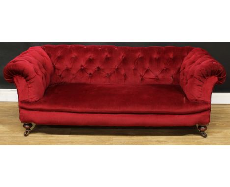 A Victorian Chesterfield sofa, stuffed-over deep button upholstery, turned forelegs, ceramic casters, 64.5cm high, 176cm wide