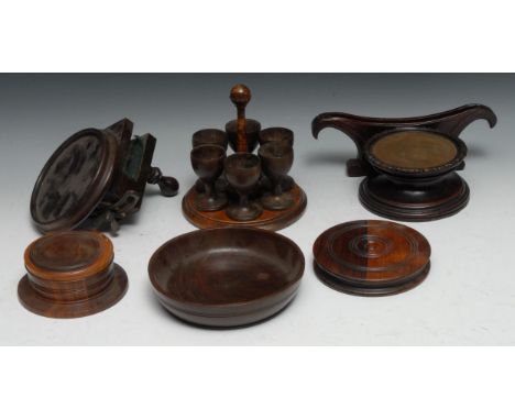 An early 20th century treen six-cup egg stand, 18.5cm high;  a treen bowl, 17.5cm diam;  table clamp;  etc 