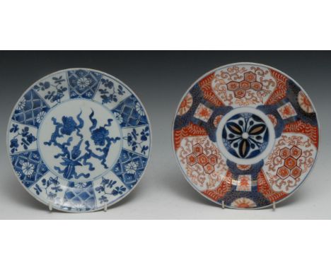 A Chinese circular plate, painted in tones of underglaze blue with flowers, within a compartmented border, 22cm diam, fret ma