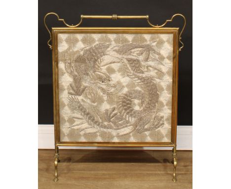 An Art Nouveau brass fire screen, the glazed banner with a Chinese silk picture, worked in raised silvered thread with a fero