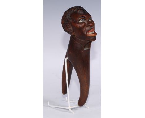 Nutcrackers - a Black Forest lever action novelty nut cracker, as as a man, painted lips and features, 22cm long, early 20th 